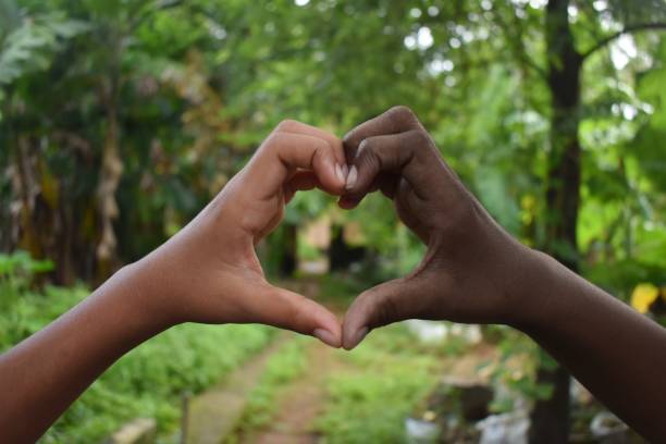 Our vision for racial Justice represented by two black hands forming a heart