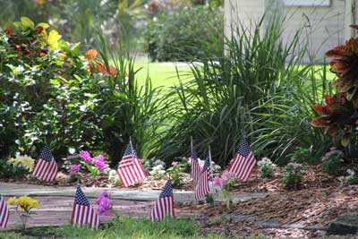 The memorial garden on the church campus with American flags in the ground