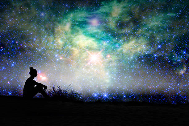 Reflection and Renewal - person sitting in the open with a beautiful night sky