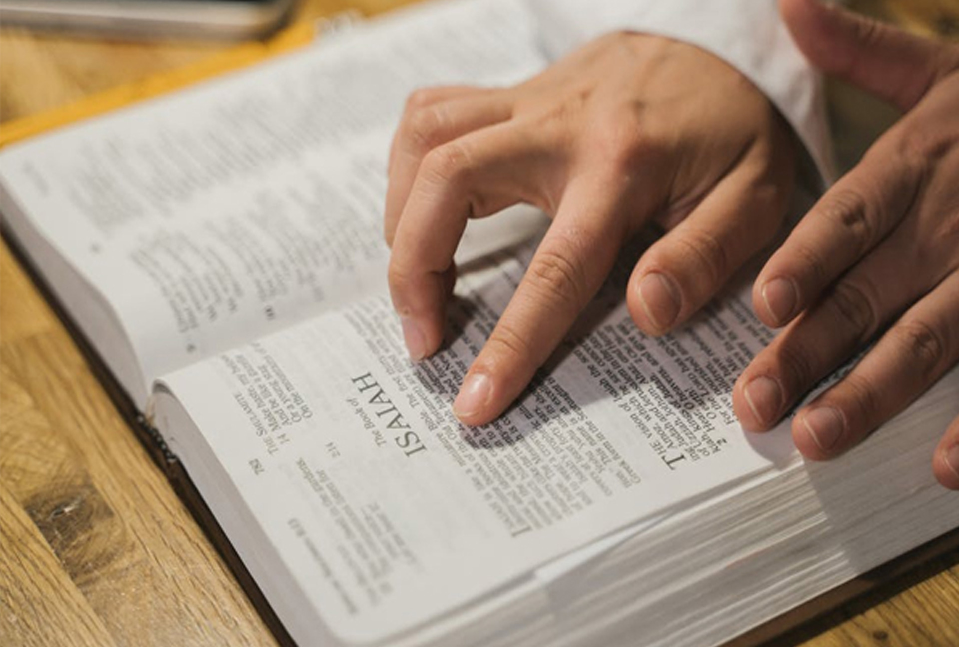 person&#039;s hands on Bible as they read